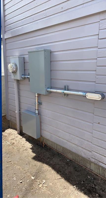Exterior electrical meter base and panel mounted on a home during a service upgrade