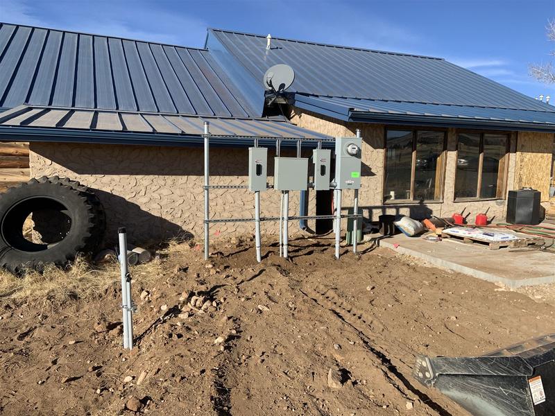 Multiple new electrical panels mounted on the exterior of a home after a service upgrade