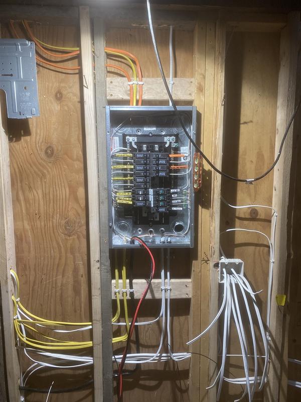 New residential electrical panel installed mid-construction with every circuit labeled